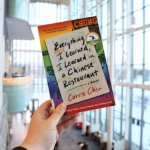 hand holding up a copy of the book, Everything I Learned, I Learned in a Chinese Restaurant by Curtis Chin. on March 25, 2026